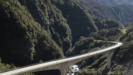 Toma-Ampliada-De-Autos-Cruzando-Un-Viaducto-En-Las-Montañas-De-Nueva-Zelanda