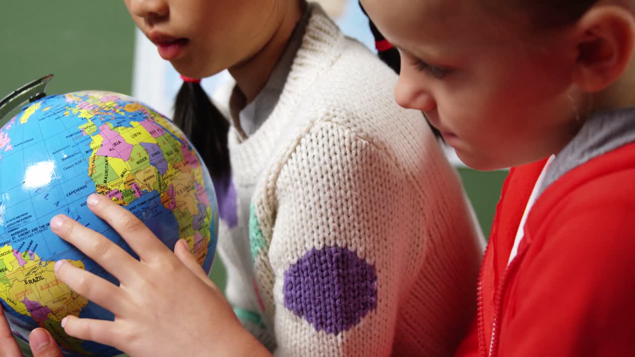 niños de la escuela mirando el globo en el aula en la escuela