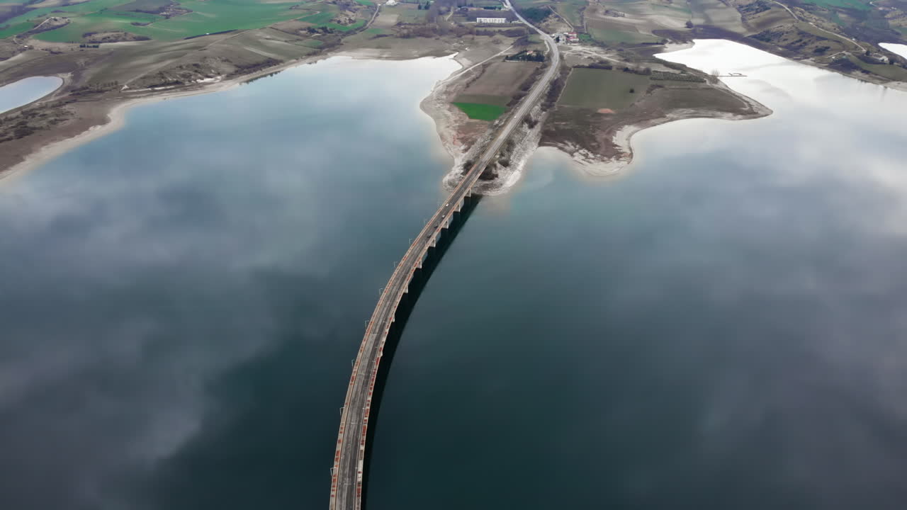 Reflective Waters Under Servia Bridge Captured in Dramatic Cloudy Light
