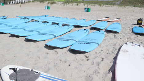 panning shot of surf boards ready for a surfing event