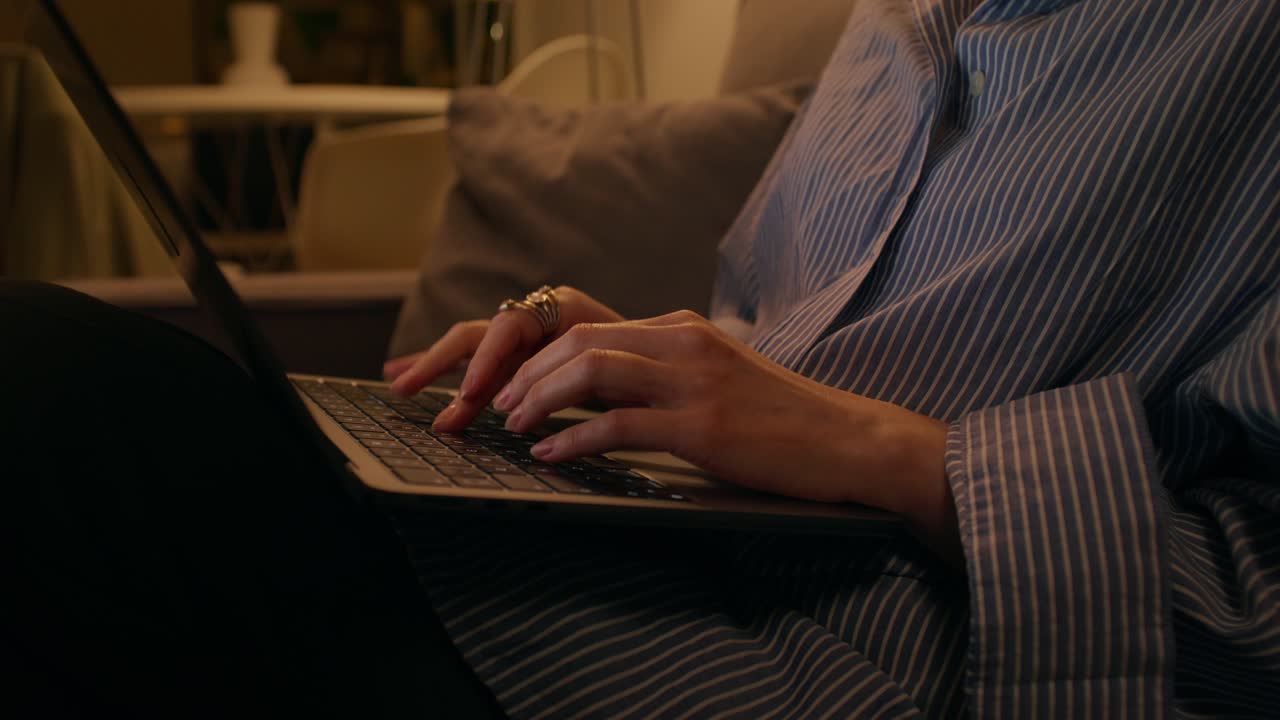 Woman working on laptop at night