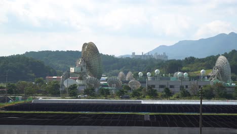 daytime kt sat satellite dishes in geumsan on beautiful mountain background, south korea