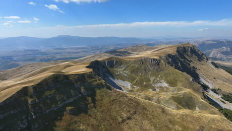 flight over beautiful mountain peaks covered with grass