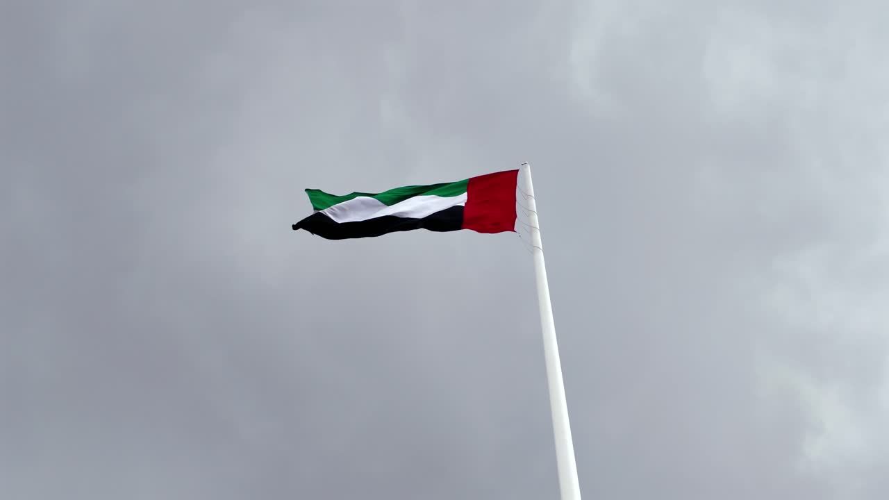 A view of the UAE national flag under overcast conditions in Sharjah