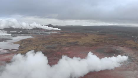 aerial shot of a bleak and barren landscape above a geothermal hot spring