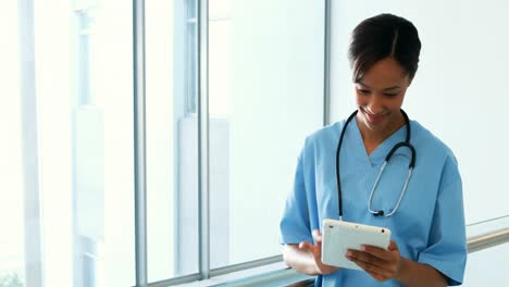 Female-doctor-using-digital-tablet-in-corridor