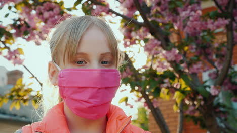 girl in pink protective mask against cherry blossoms 1