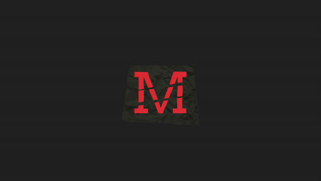 red letter m on crumpled paper