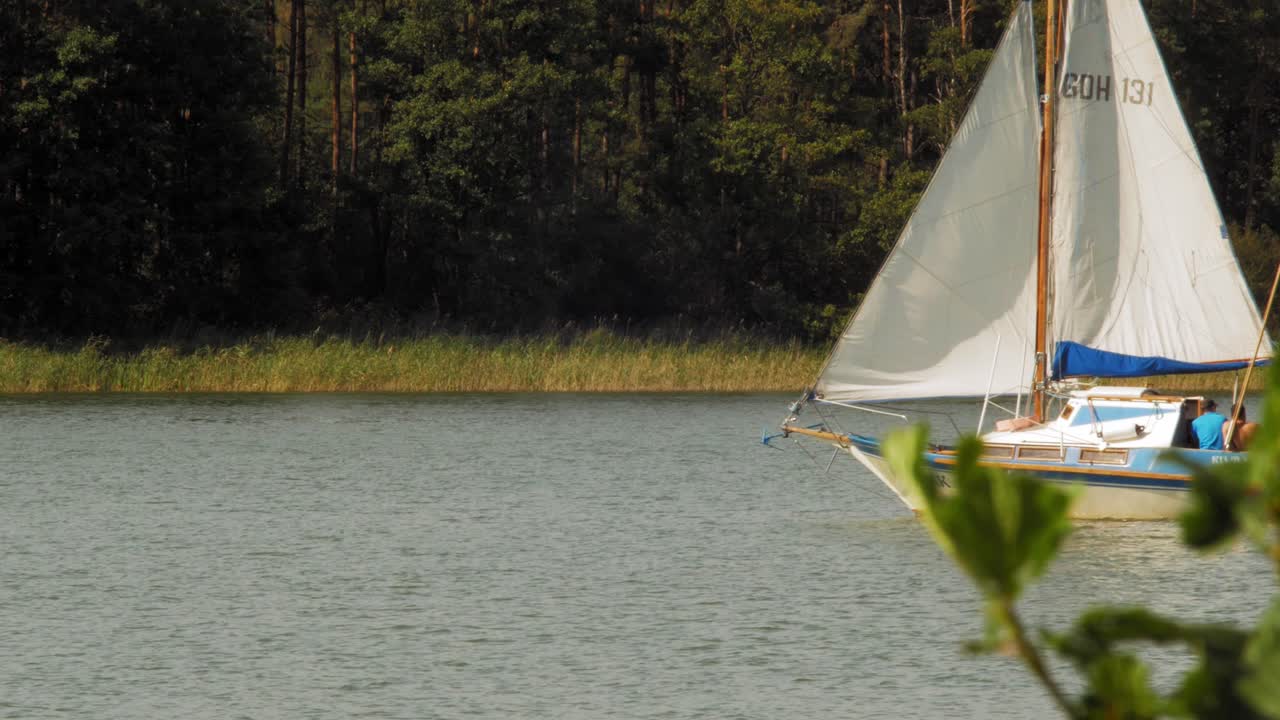 two-masted  Yacht sailing in Wdzydze Lake in Kaszubski park krajobrazowy in Pomeranian Voivodeship
