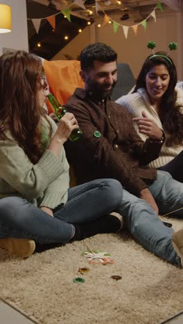 vertical video of friends dressing up at home celebrating at st patrick's day party making video call on mobile phone 2