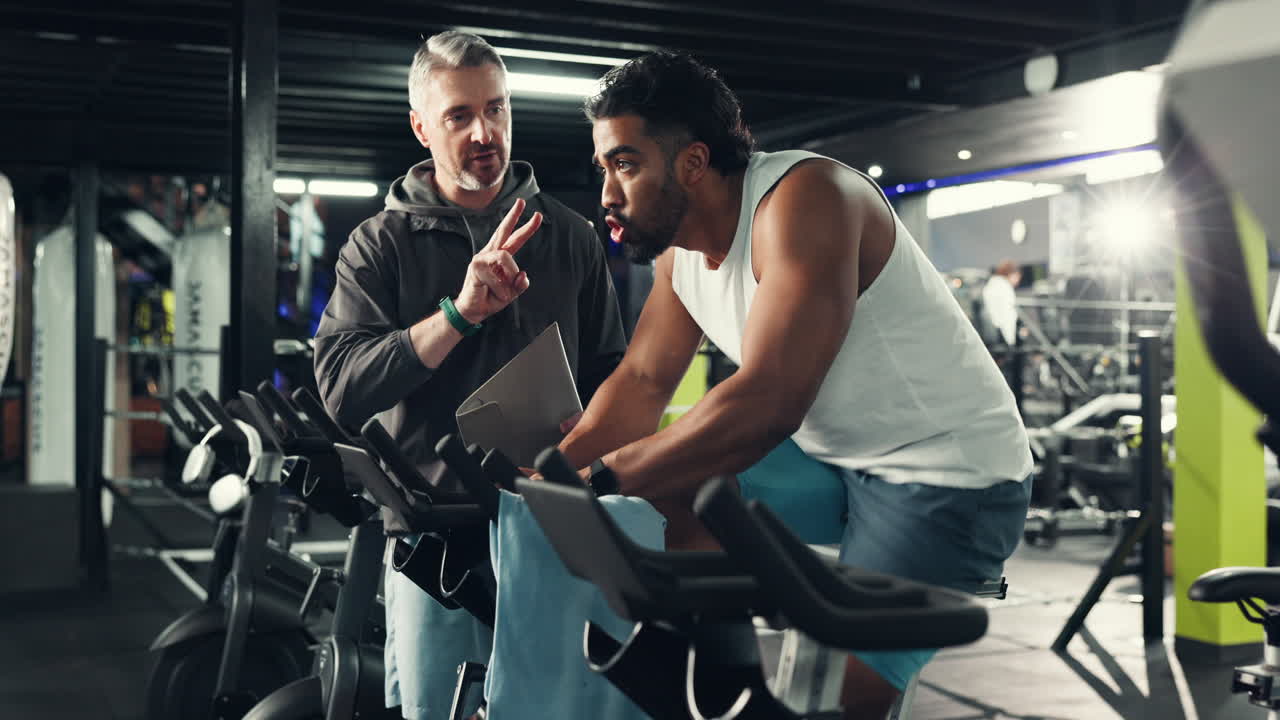 Men working out in the gym with a coach