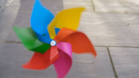 single multi coloured rainbow pinwheel spinning very fast