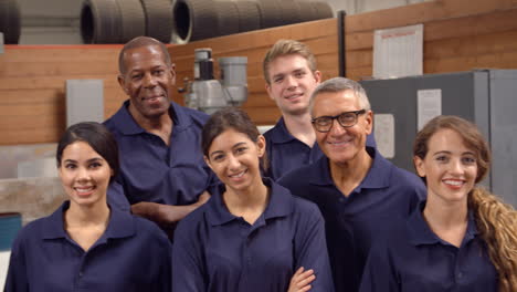 portrait of engineers and apprentices in busy factory