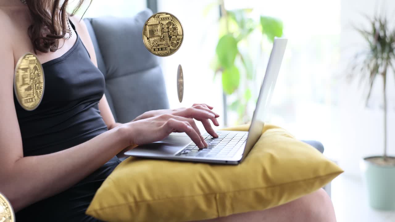 Woman using laptop with Bitcoin graphics