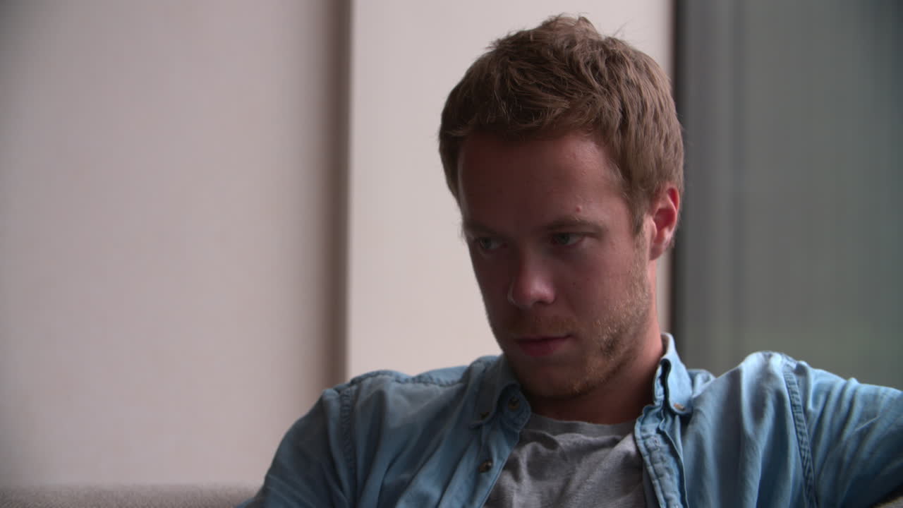 Close Up Of Depressed Young Man At Home