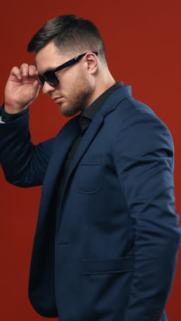 portrait of businessman on background. handsome young man in suit looking at camera while standing against background . vertical video