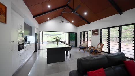 modern tropical villa interior with spacious open-plan layout, large windows, and luxury furnishings for a relaxing living space.