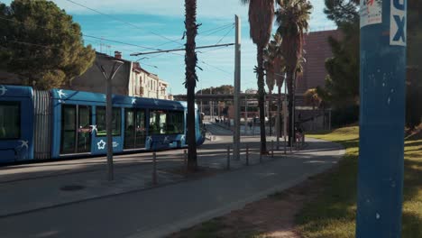 a blue tram moving in the morning