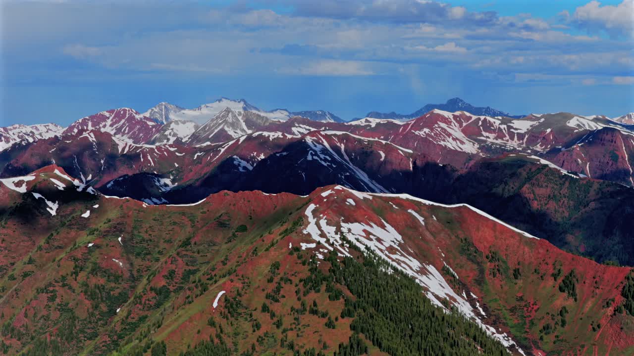Snowmass Mountain Capitol Peak Aspen Highlands bowl spring summer Maroon Bells Wilderness Elk Mountain Range aerial drone Colorado Pyramid Peak 14er sunny morning blue sky clouds parallax circle left