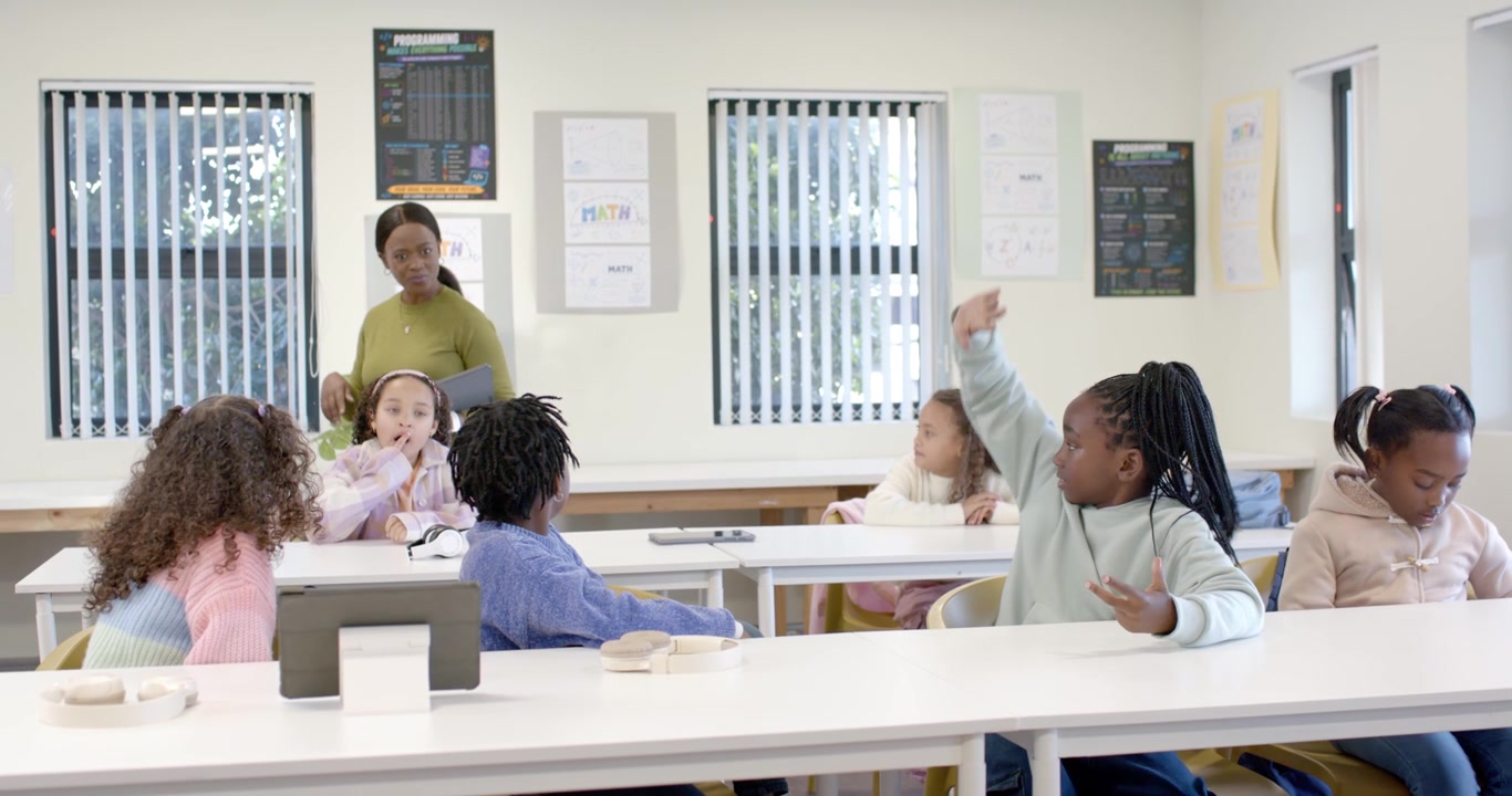 Diverse class teacher raising hand with tablet, calling, elementary kids turning counting reaching