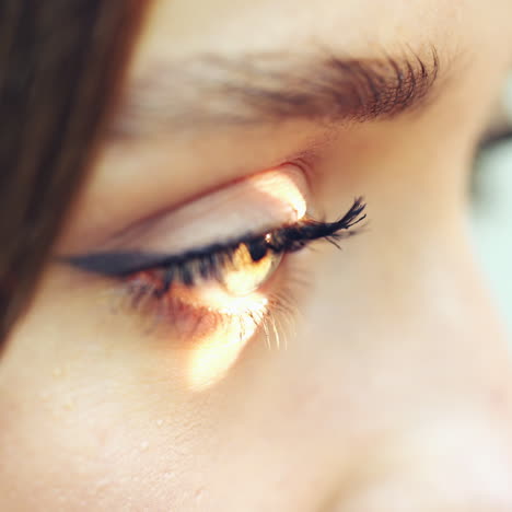 side view of woman's eye. laser shining into the eye of a patient during eyes examination. close-up. eyesight concept.