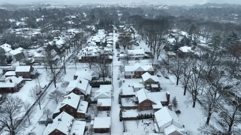 aerial reveal of a suburban landscape with snow