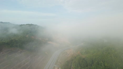foggy sunset early morning during raining season asian tropical rain forest, with mountain and green valley,palm oil farm,sarawak,borneo.