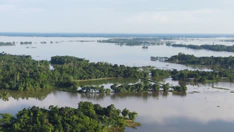 aerial view of floodwaters covering land in rural sylhet, bangladesh