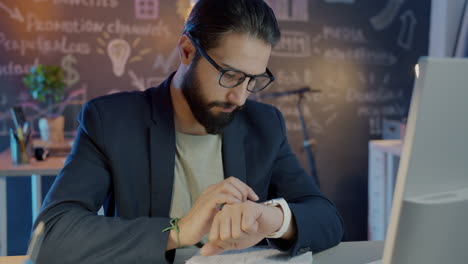 businessman checking time at workplace