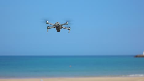 Video-En-Cámara-Lenta-De-Un-Dron-Iniciando-Su-Viaje-Hacia-El-Mar-Desde-La-Playa