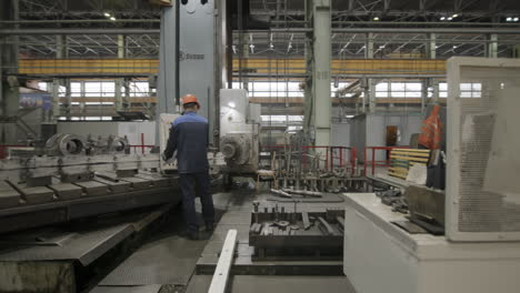 worker operating a large industrial machine in a factory