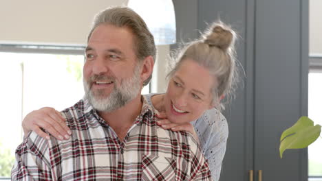 happy mature couple enjoying cozy moment together at home, smiling warmly
