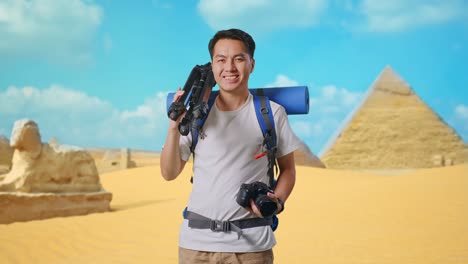 happy traveler with tripod and camera in the egyptian desert