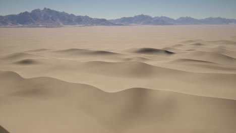 arid landscape with sand dunes and mountains