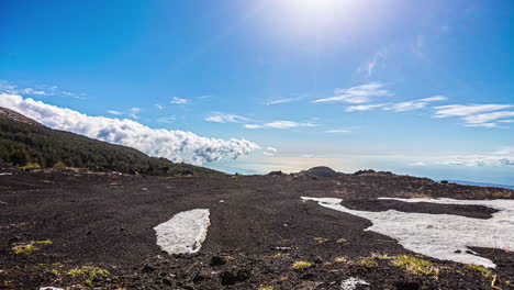 static view over etna's south eastern crater with few patches of snow remaining from the winter season