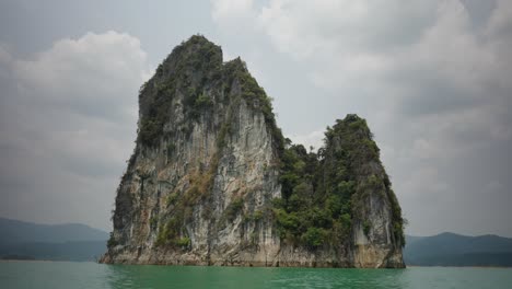 towering limestone karst island in a tropical lake