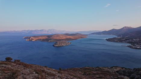 scenic coastal view of islands and mountains at twilight near a harbor