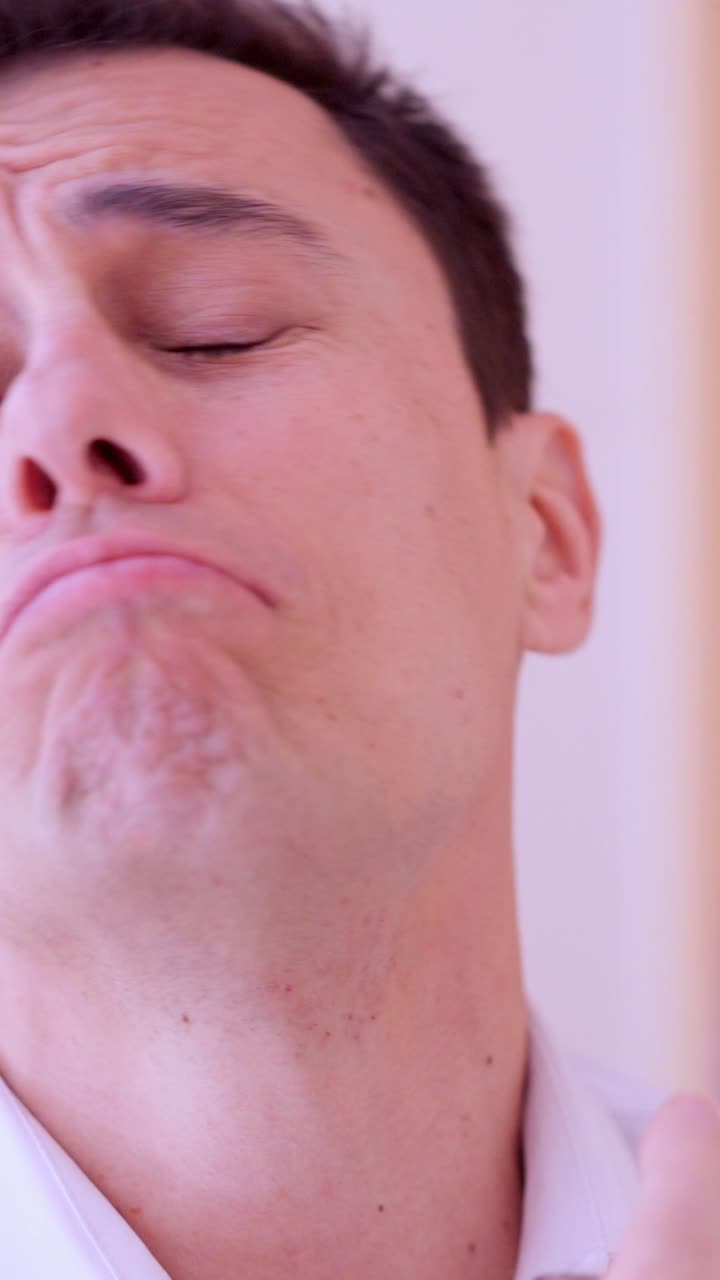 Businessman applying perfume and enjoying fragrance