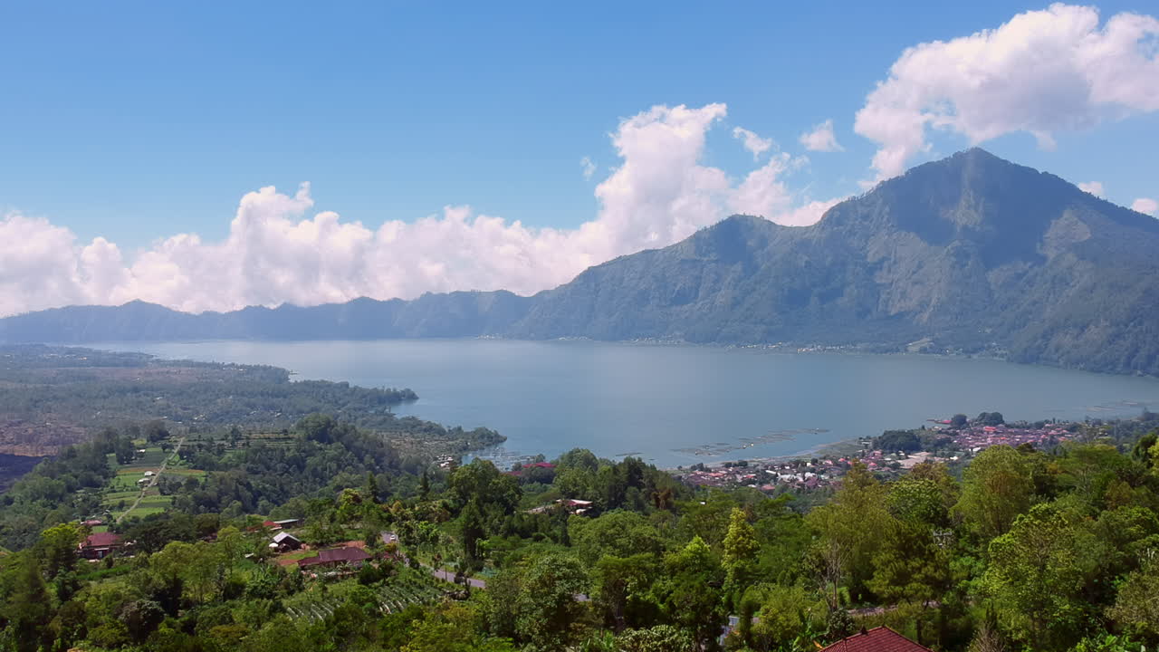 Drone Shot of the lake Danau Baturm with mountains in the background (Gunung Abang Kintamani).