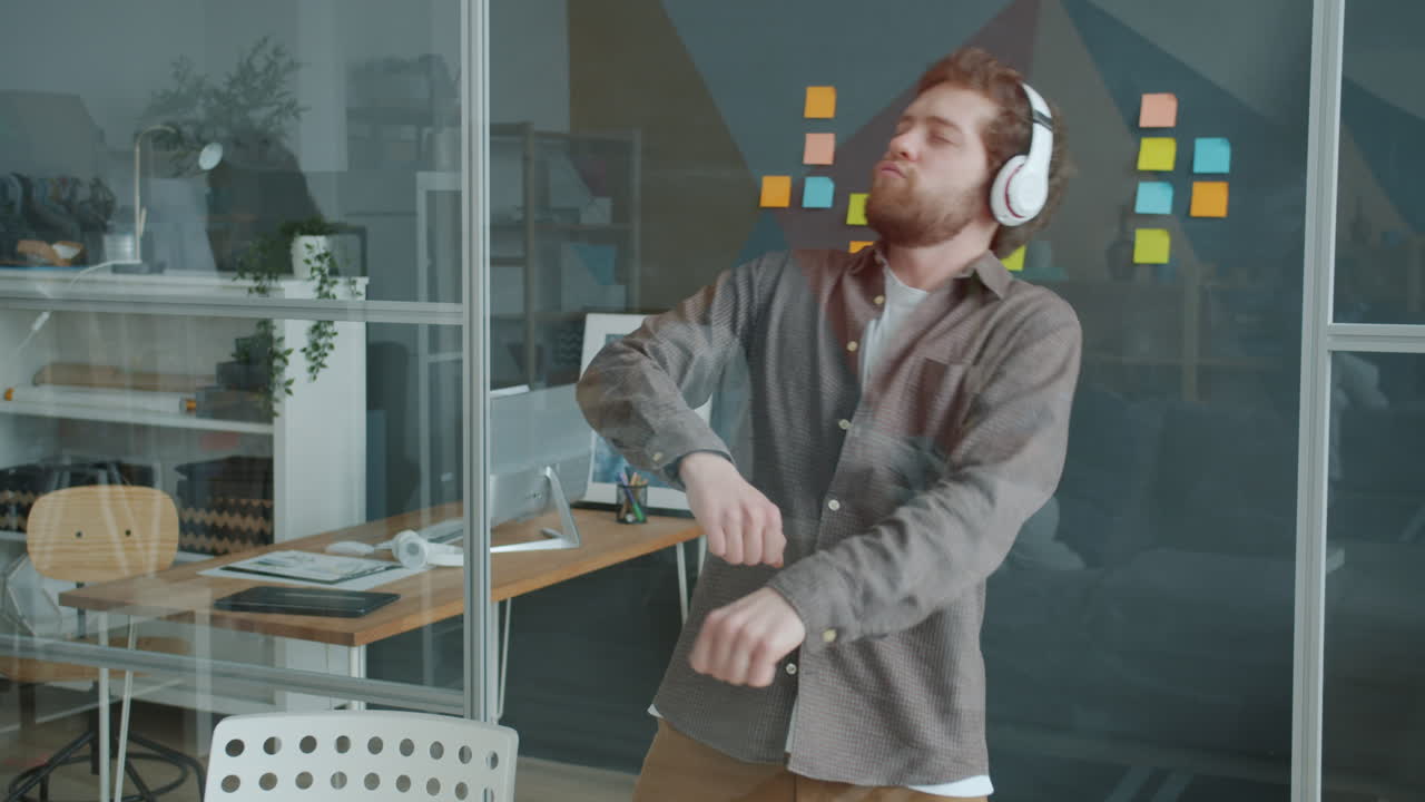 Man Dancing in Office with Headphones