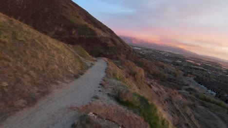 following the path at slate canyon over the mountain overlooking utah valley, huge sunset sky in the background