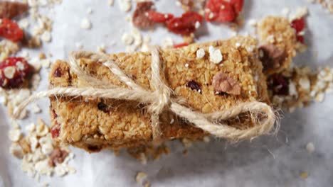 granola bars tied with string on wax paper 4k