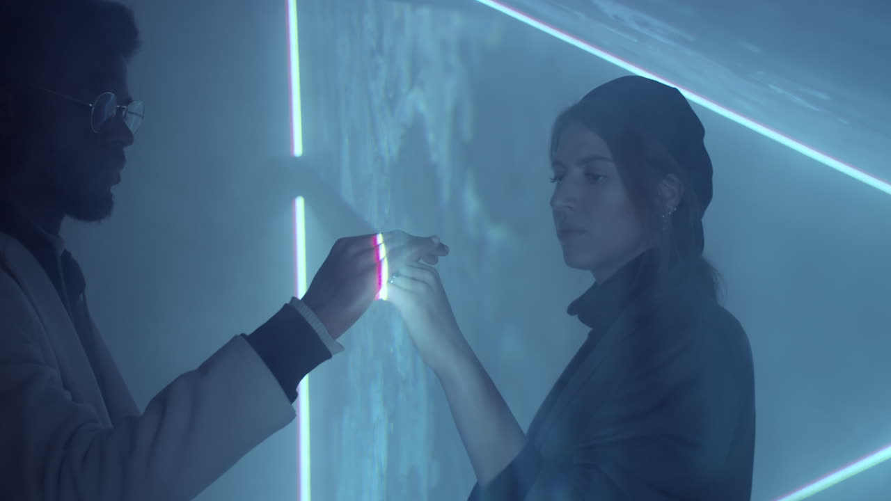 Diverse Man and Woman Touching Hands through Laser Light Sheet