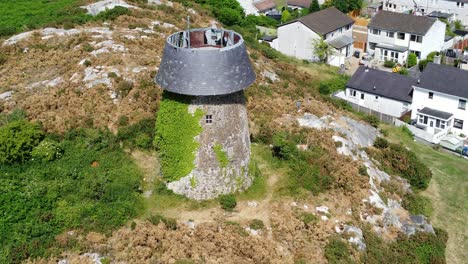 Llangefni-ivy-covered-hillside-windmill-landmark-aerial-view-orbiting-Welsh-historical-mill