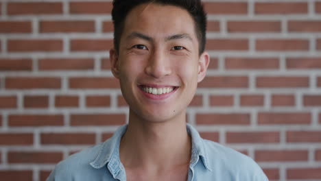 portrait independent young asian man laughing enjoying success looking happy confident male student slow motion