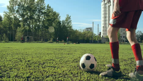 kids wearing soccer kit playing soccer outdoors