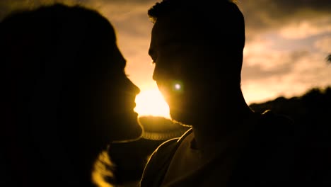 couple kissing at sunset silhouette