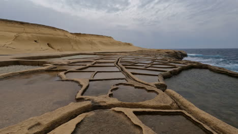 Traditional-salt-pans-in-Xwejni-Bay-on-the-island-of-Gozo,-Malta