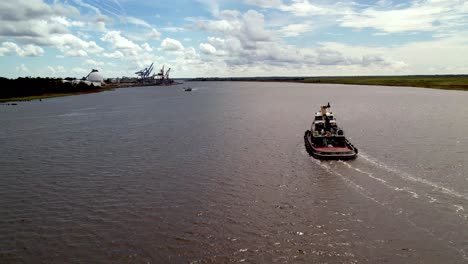 Tug-boat-aerial-along-the-cape-fear-river-near-wilmington-nc,-north-carolina