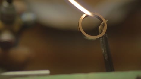 italian goldsmith at work building an engagement or a wedding ring